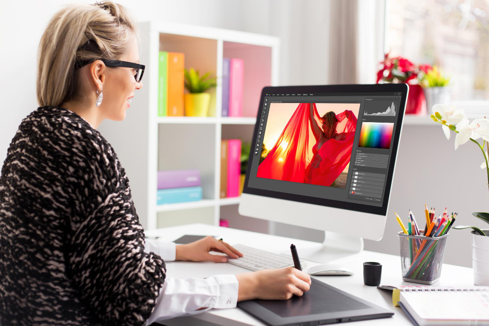 A woman is working on a computer at home.